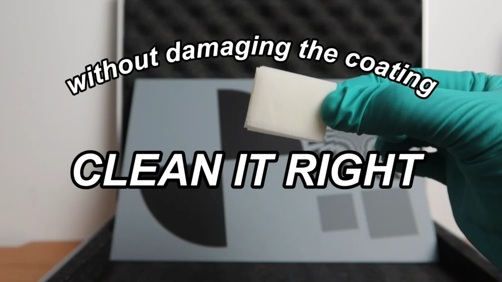 Cleaning a glass calibration target with gloves, an air blower, and a lint-free lens wipe